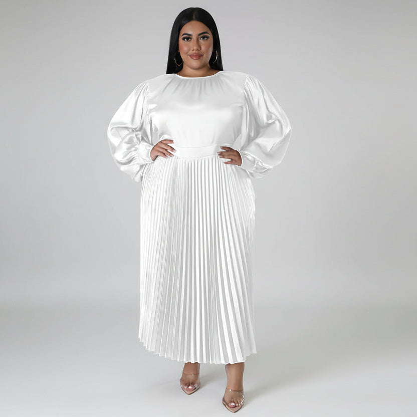Woman wearing a white pleated dress with long sleeves on a white background