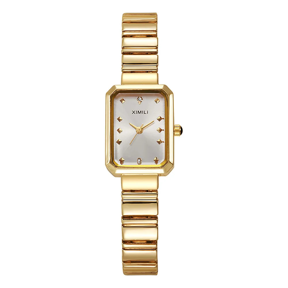 Gold wristwatch with a silver face on a white background