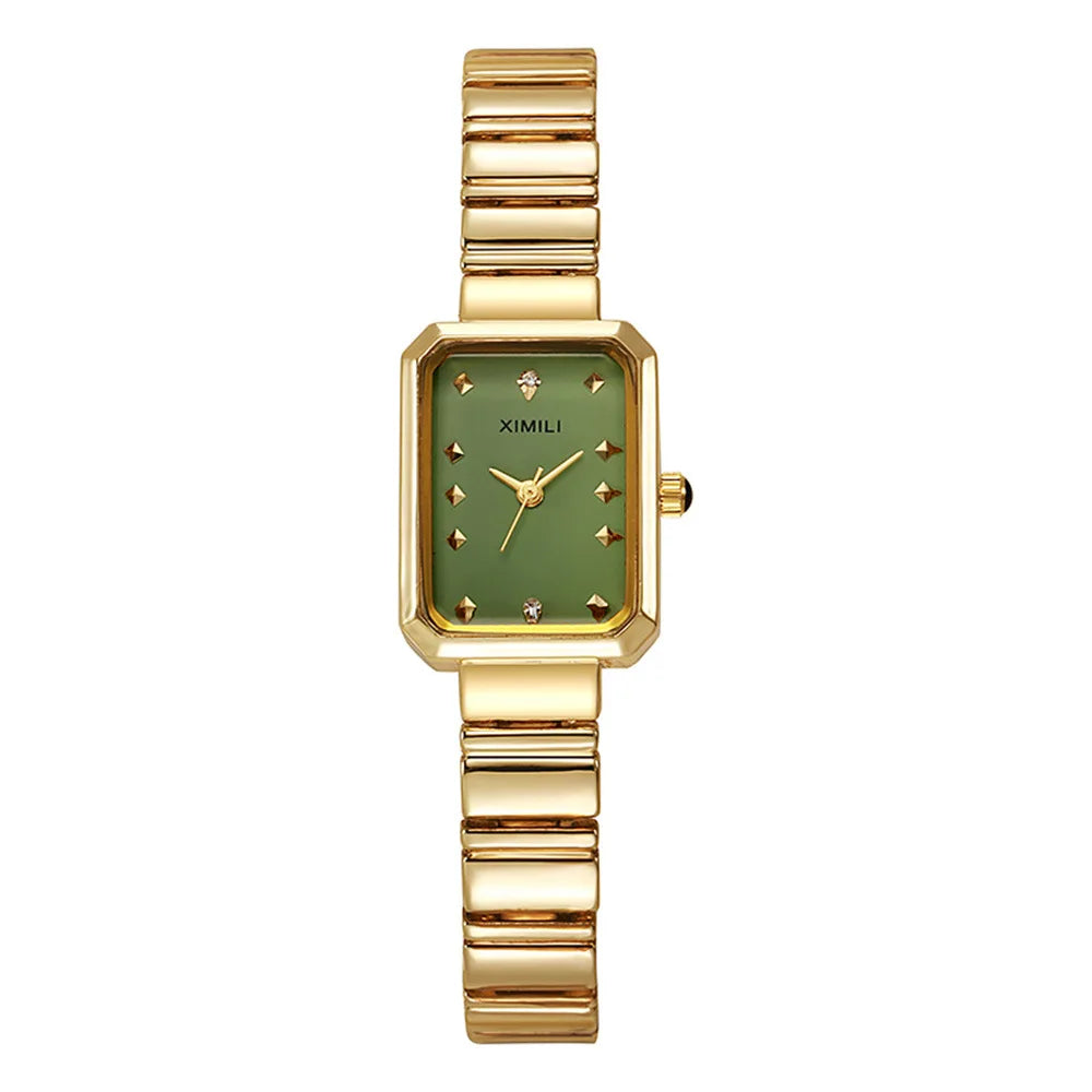 Gold watch with a green face on a white background